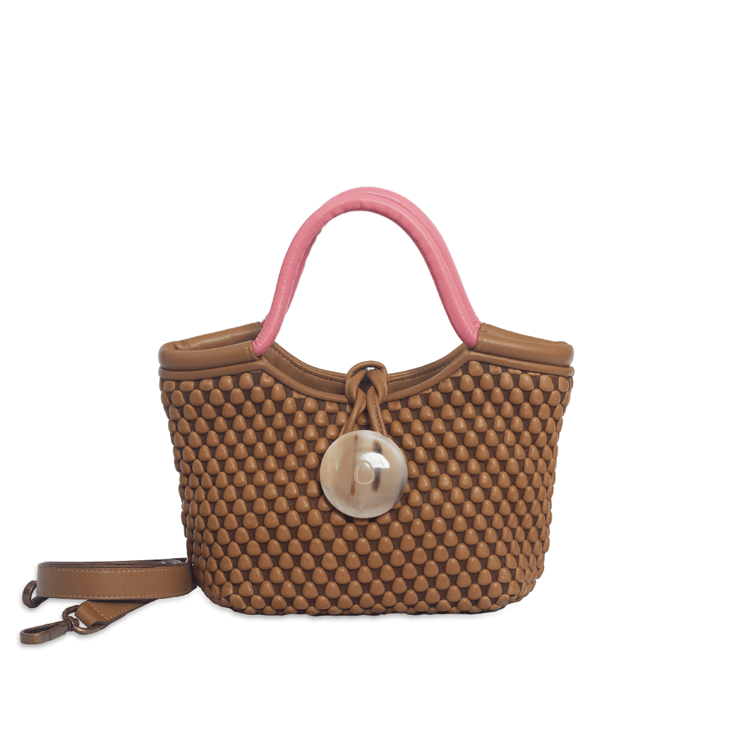 Distinctive shaped, Dual Tone handbag made of Spanish Nappa Leather which exquisitely combines nappa bubbles, a horn button closure and velvety soft lambskin top handles. Can be worn as a chic evening bag or sling it cross-body with the detachable strap for an everyday statement piece.