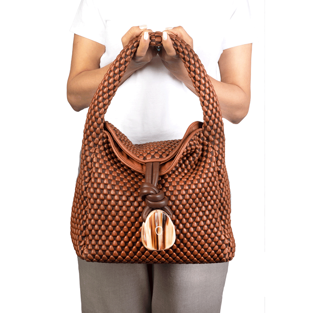 A foldover leather handbag with horn detailing. Perfect for an everyday bag. Made of Spanish Nappa Leather