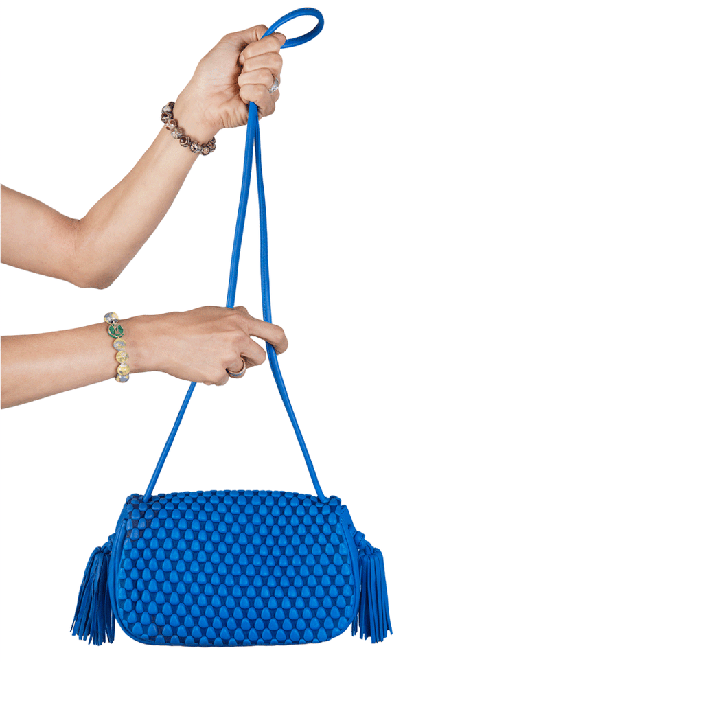 A flapover luxury leather bags with tassle detailing. This can be used as a crossbody for day and evening as a clutch. Made of Spanish Nappa Leather